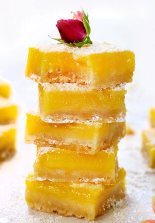 a stack of lemon bars showing how thick and creamy they are