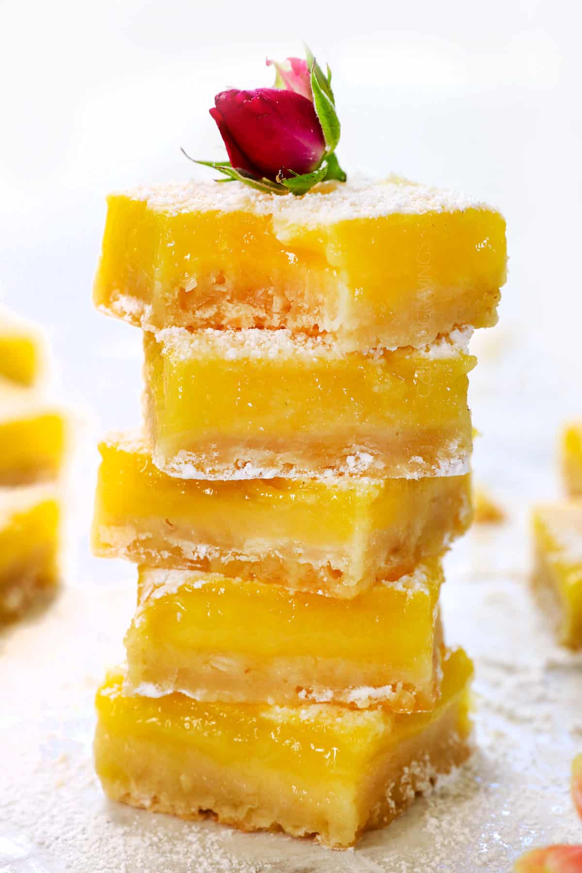 a stack of lemon bars showing how thick and creamy they are