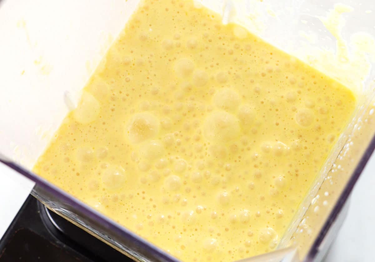 showing how to make orange Julius by blending the orange juice, sugar and vanilla until smooth and frothy