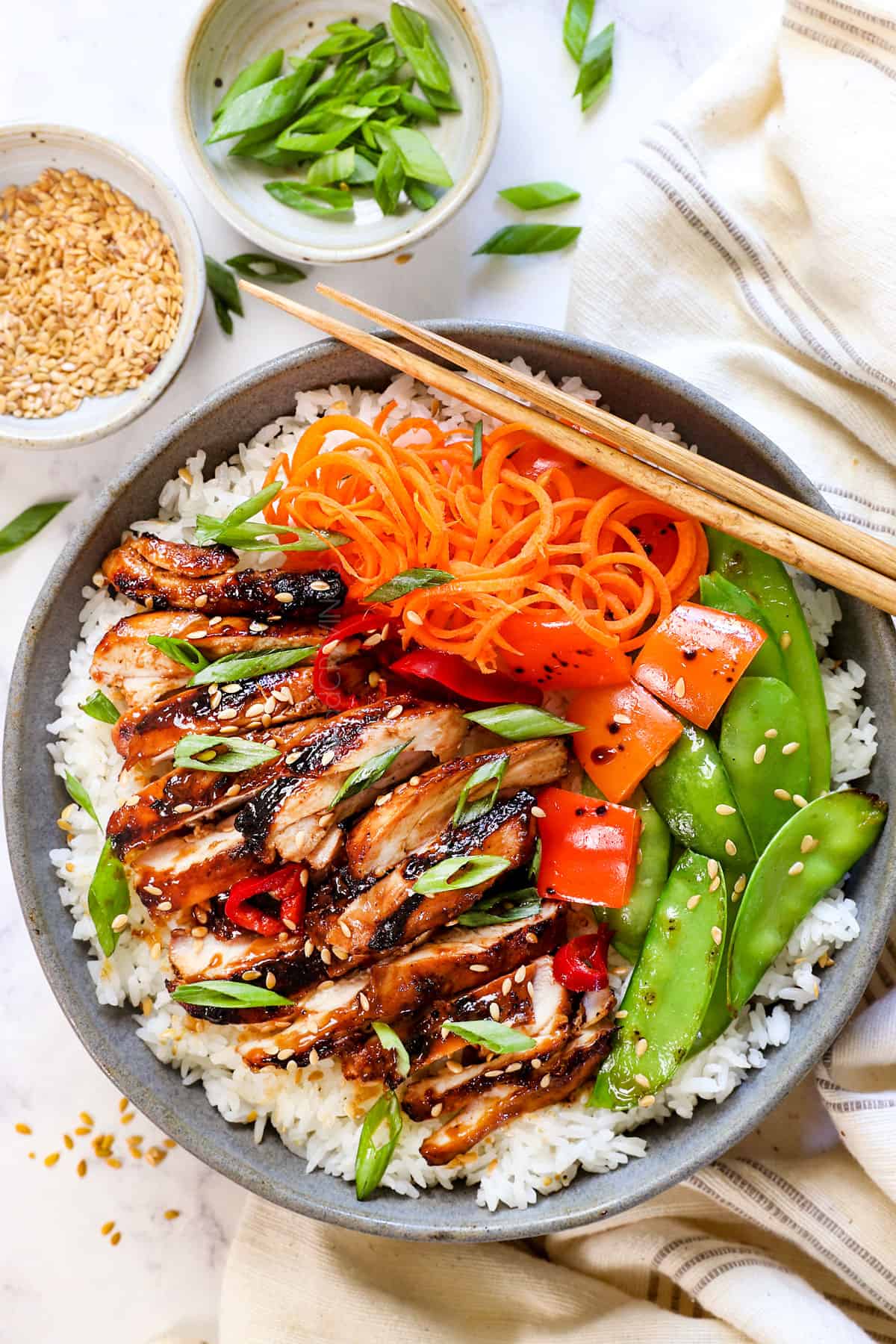 showing how to serve Asian chicken marinade recipe in a bowl with rice and vegetables