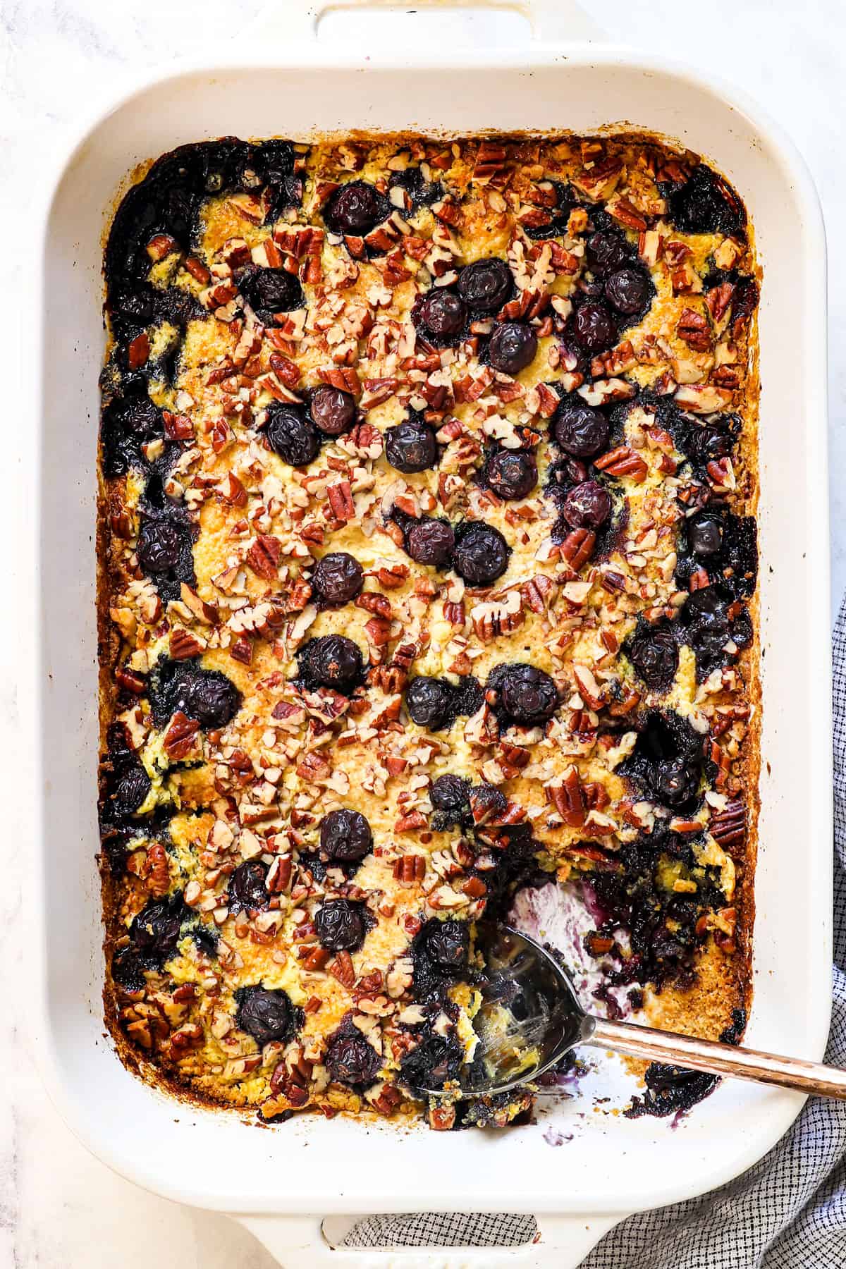 showing how to make a blueberry dump cake by baking the cake until golden