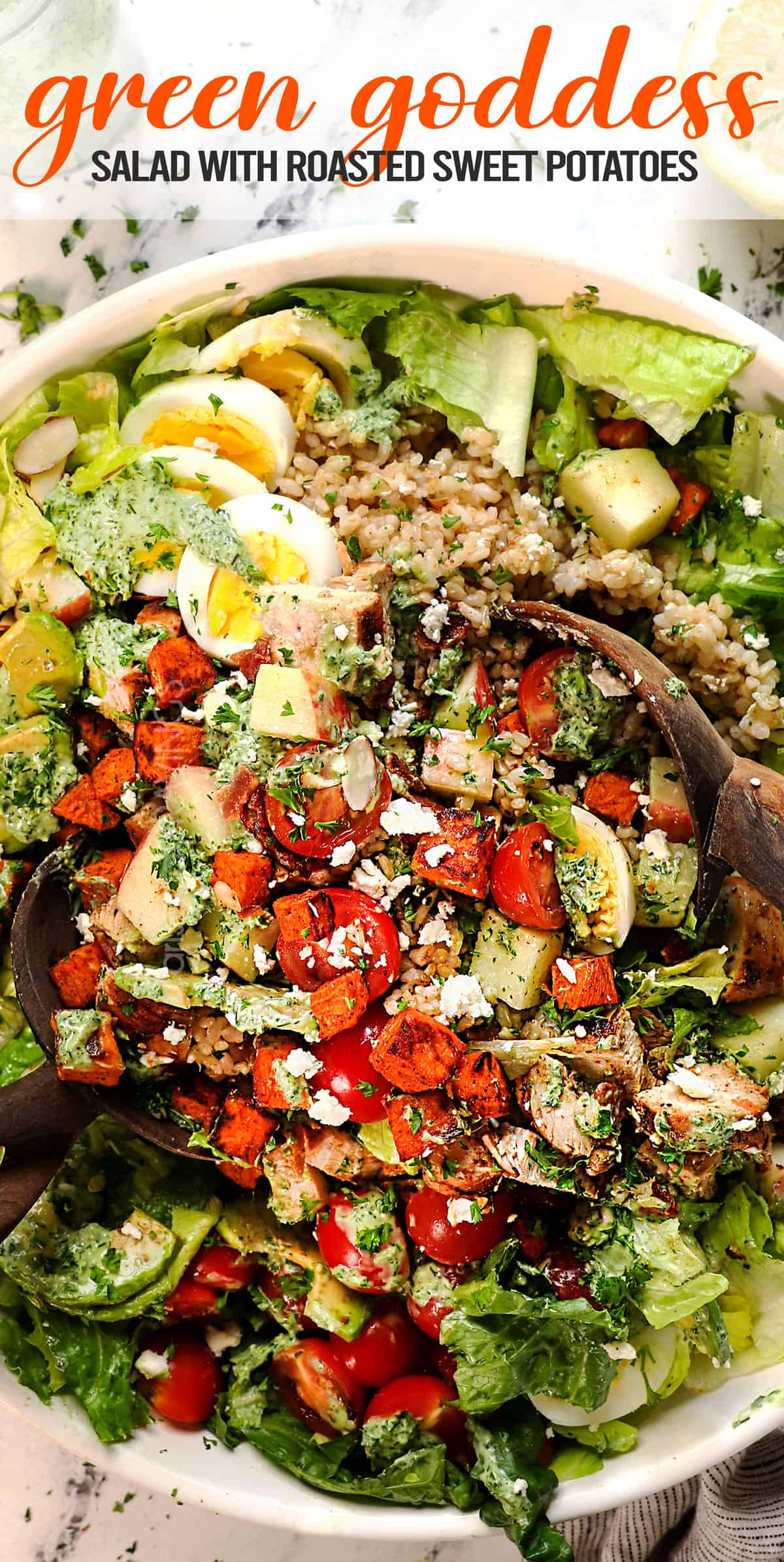 top view of green goddess salad being tossed