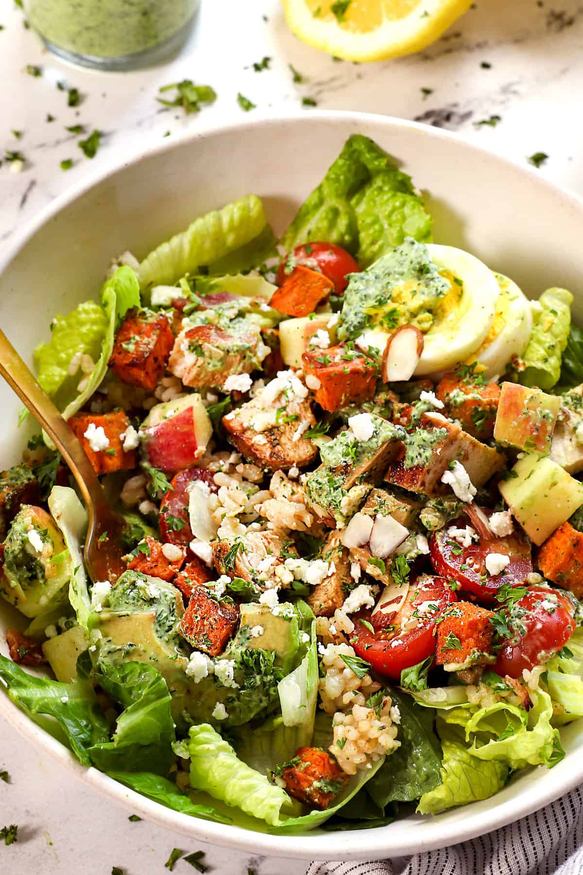 up close of a bowl green goddess chopped salad showing the ingredients