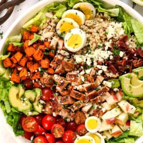 showing how to make green goddess salad by adding the ingredients to a bowl