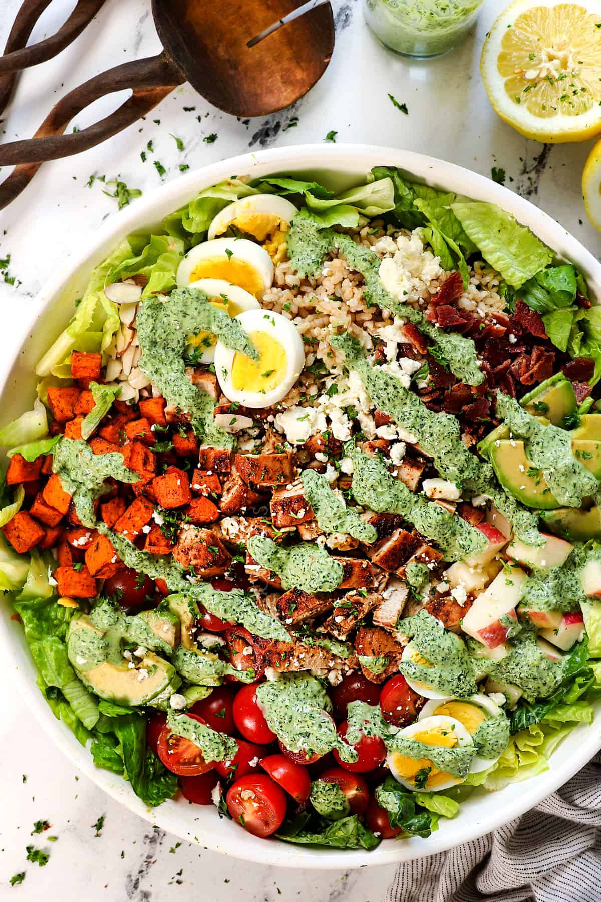 top view of green goddess salad recipe drizzled with green goddess dressing