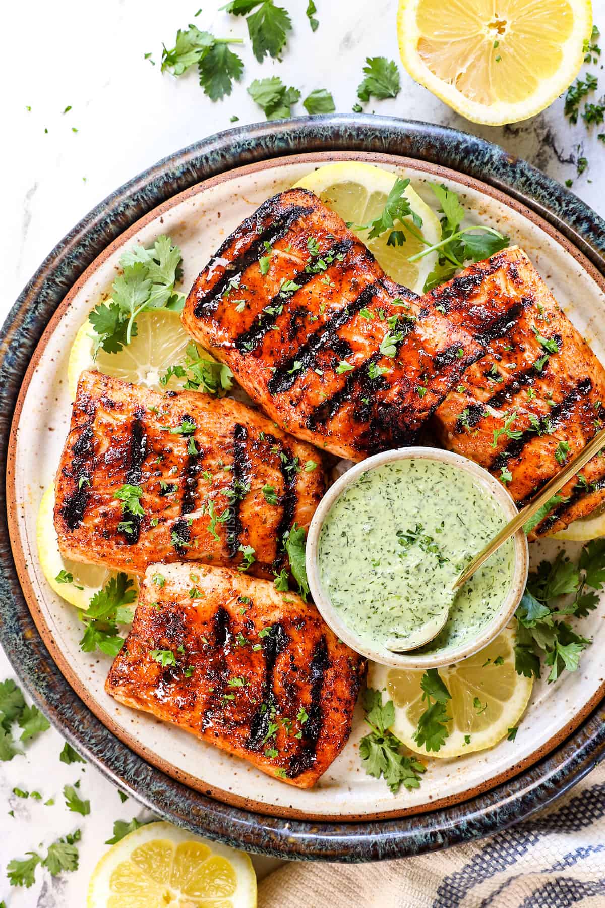 top view of grilled mahi mahi recipe on a serving platter with sauce