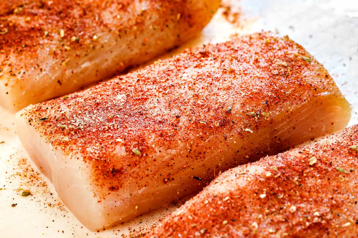 showing how to grill mahi mahi by seasoning with spice mix before grilling