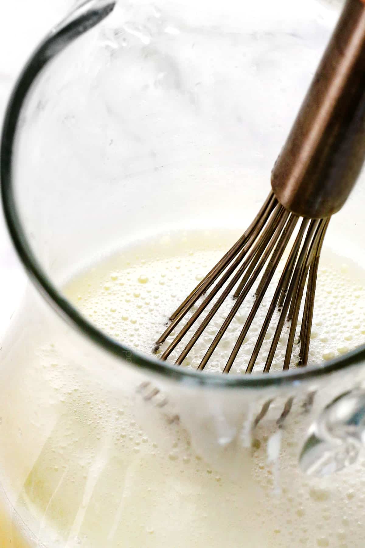 showing how to make Brazilian Lemonade by whisking the sweetened condensed milk until frothy 