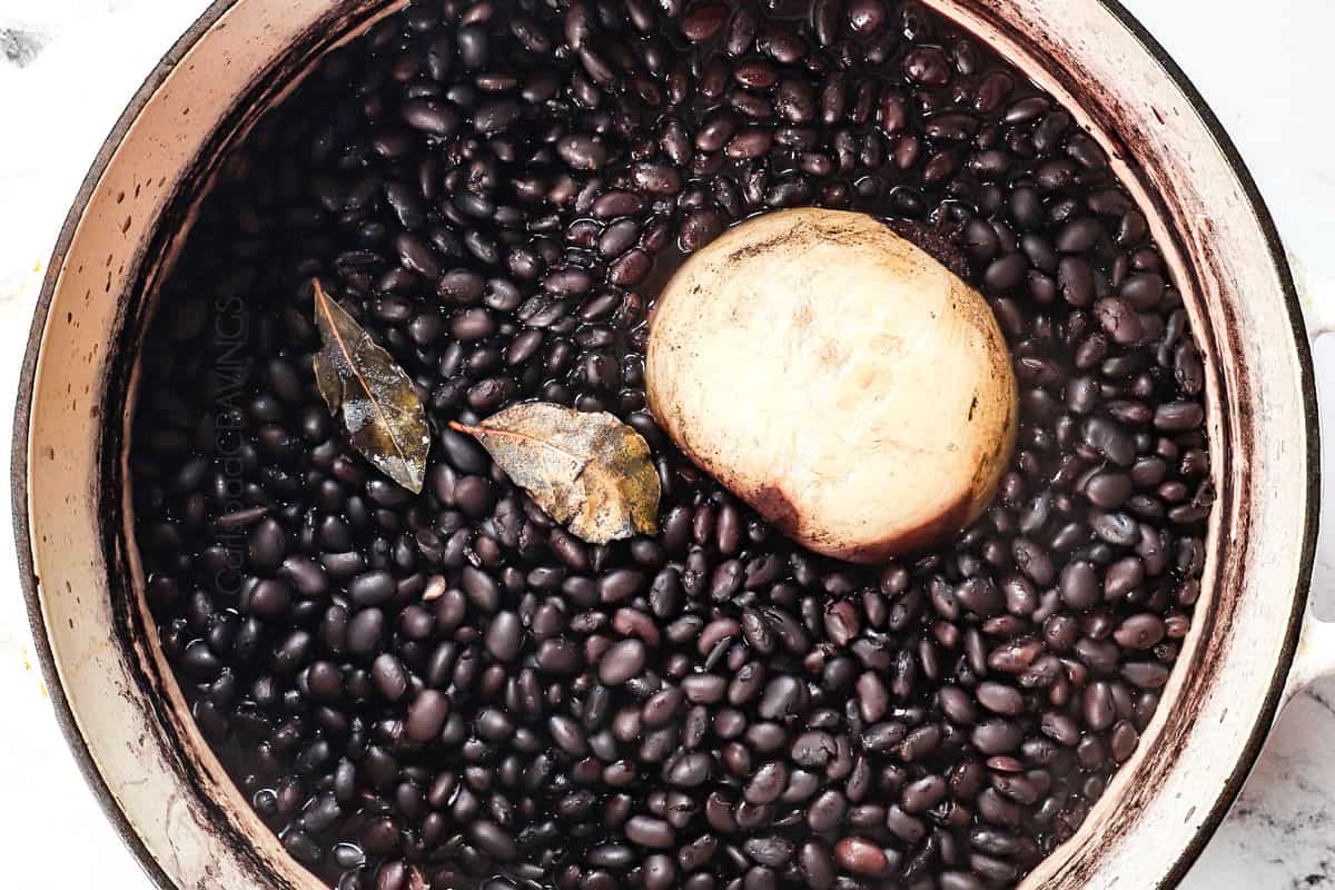 showing how to cook dried black beans by simmering until the beans are tender