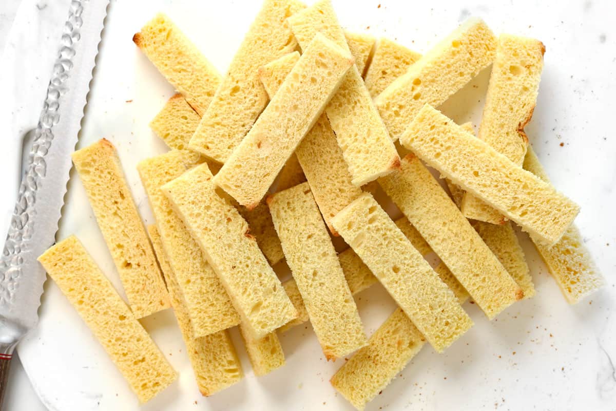 showing how to make French toast sticks with  top view of brioche bread sliced into sticks