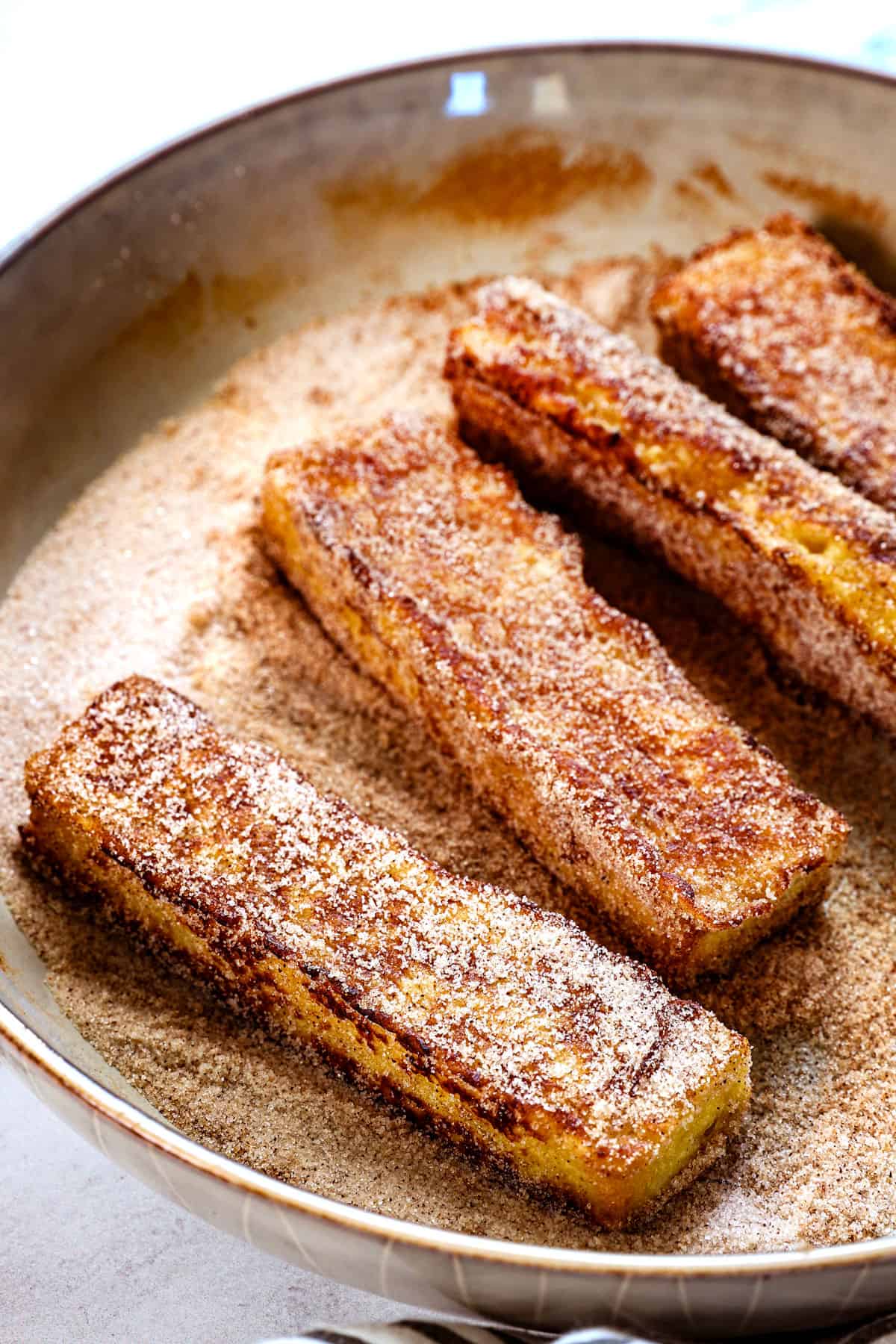 showing how to make French toast sticks by tossing the sticks in cinnamon and sugar