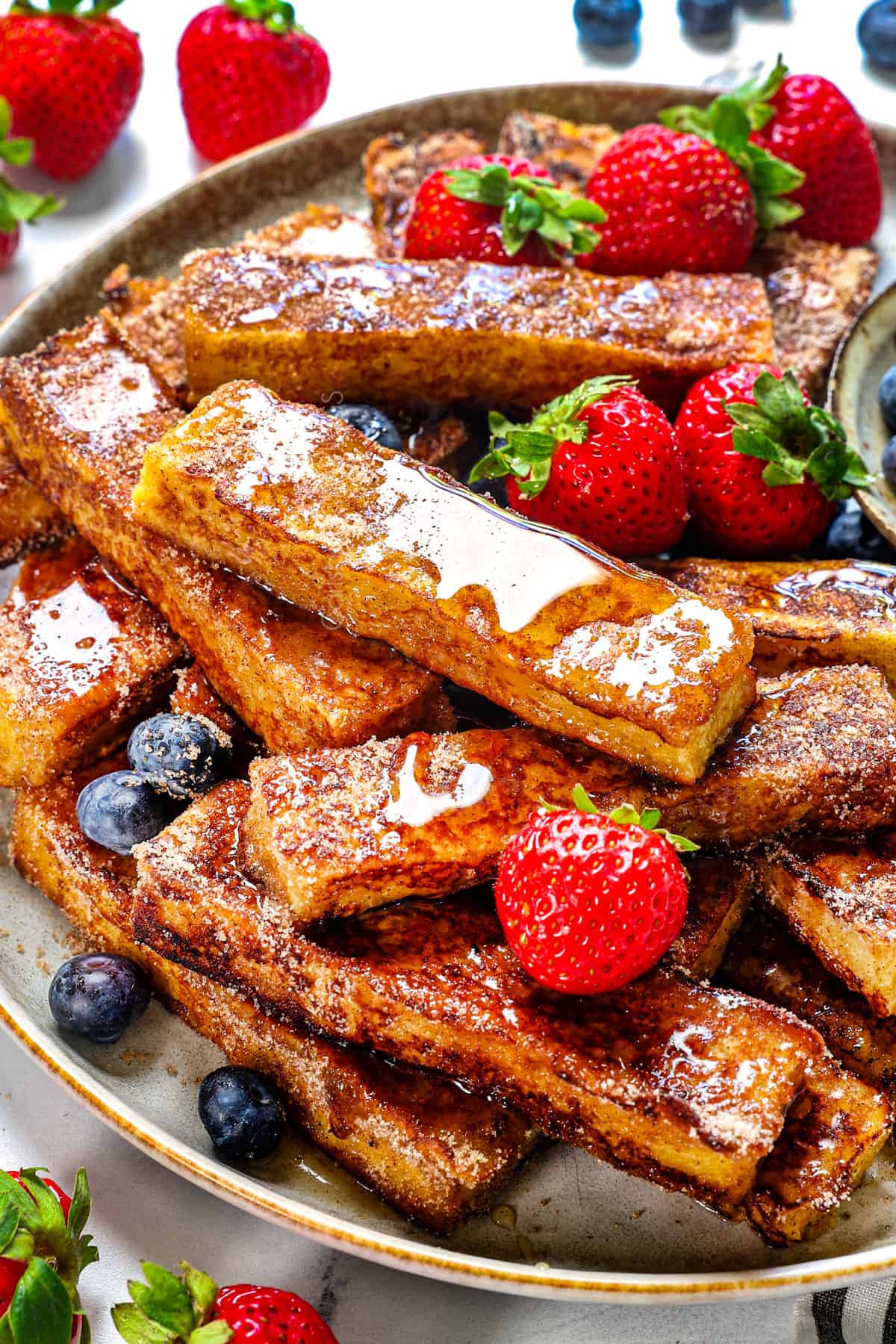 showing how to serve French Toast Sticks recipe with berries on a platter