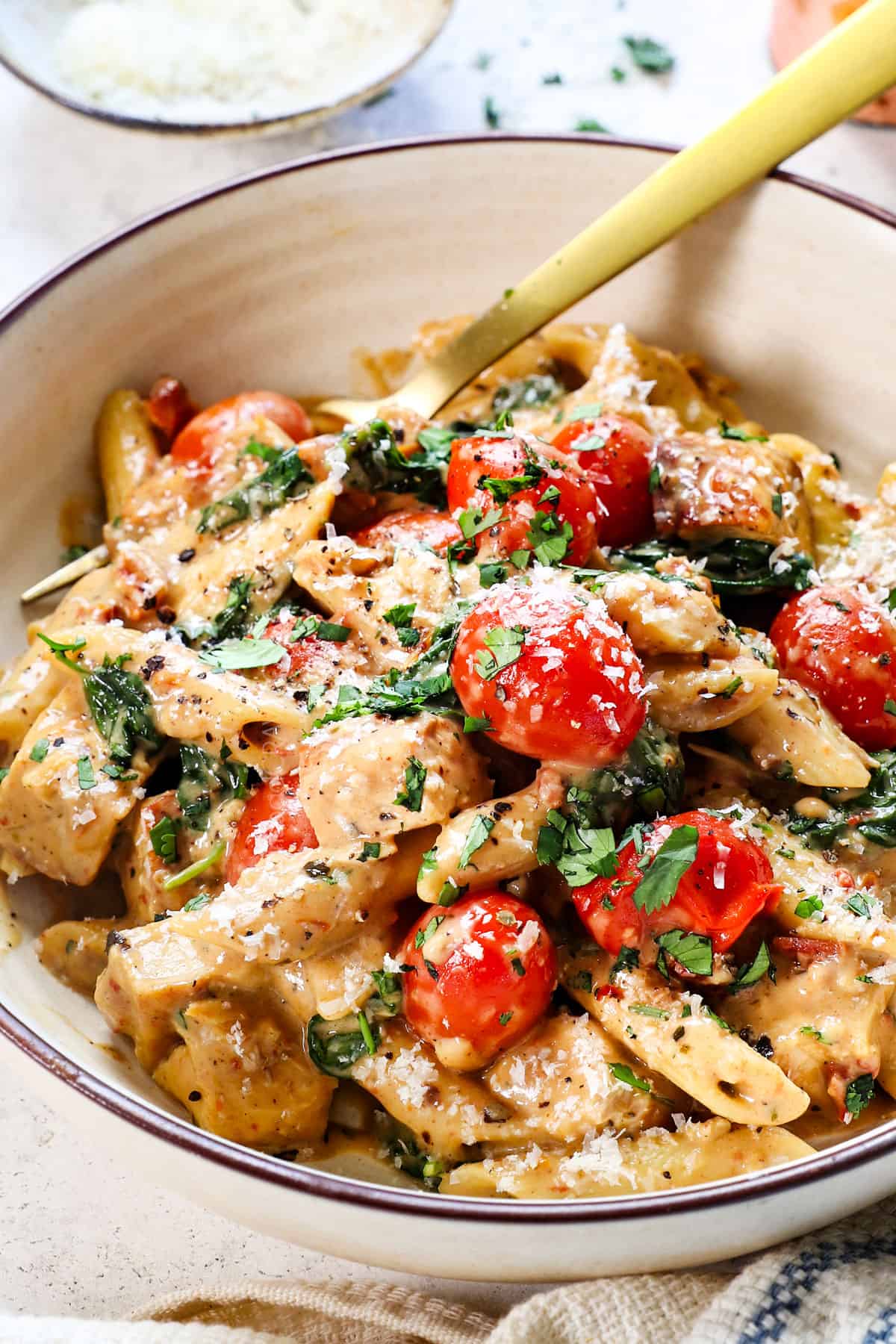 chicken Tuscan pasta made with penne pasta in a bowl