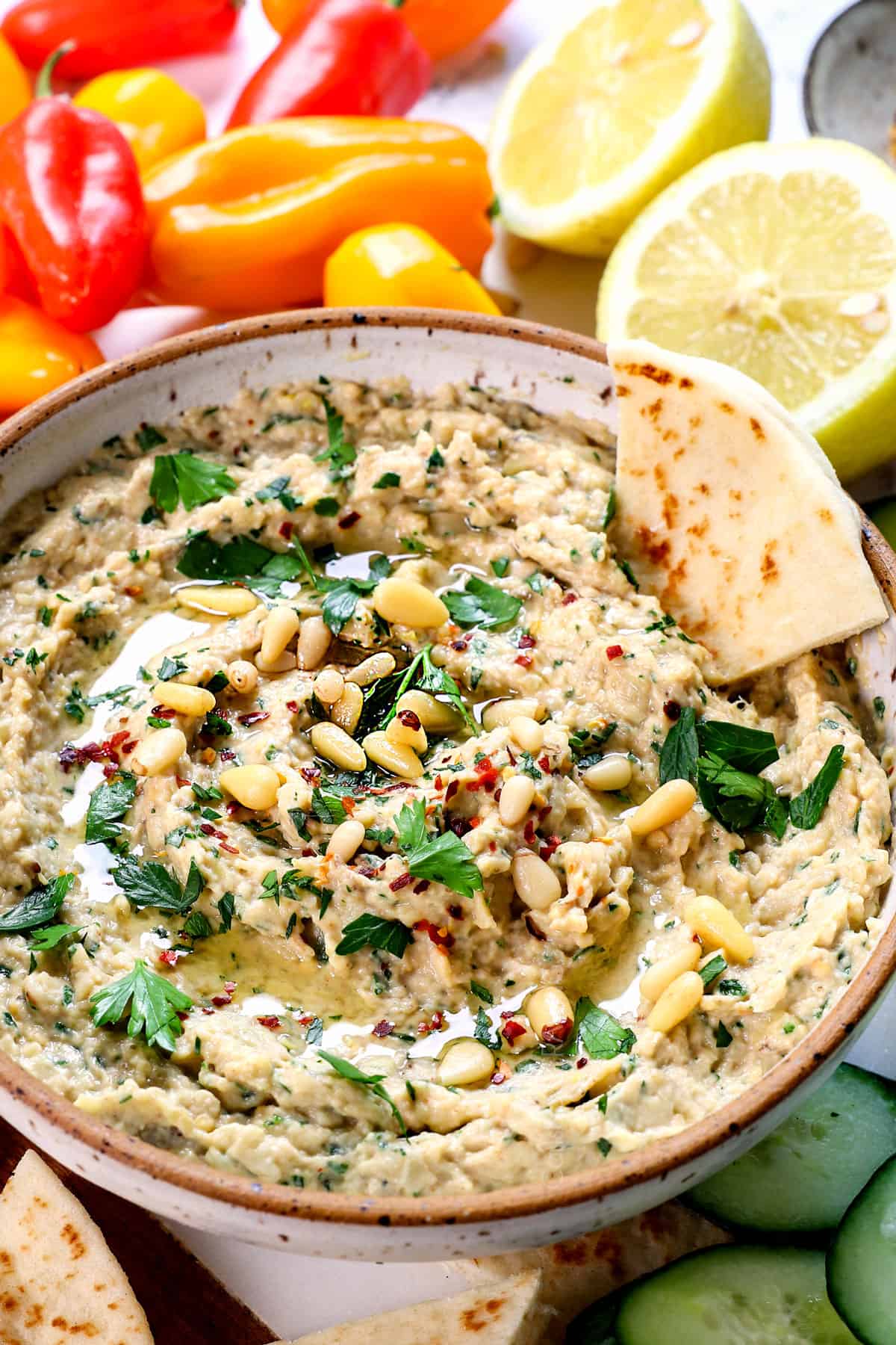 baba ganoush recipe being served with pita wedges, bell peppers and cucumbers