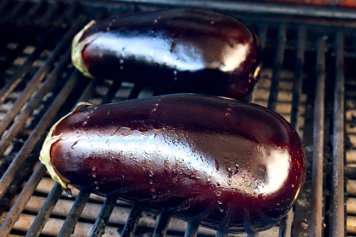 showing how to make baba ganoush by cooking the eggplant on the grill 