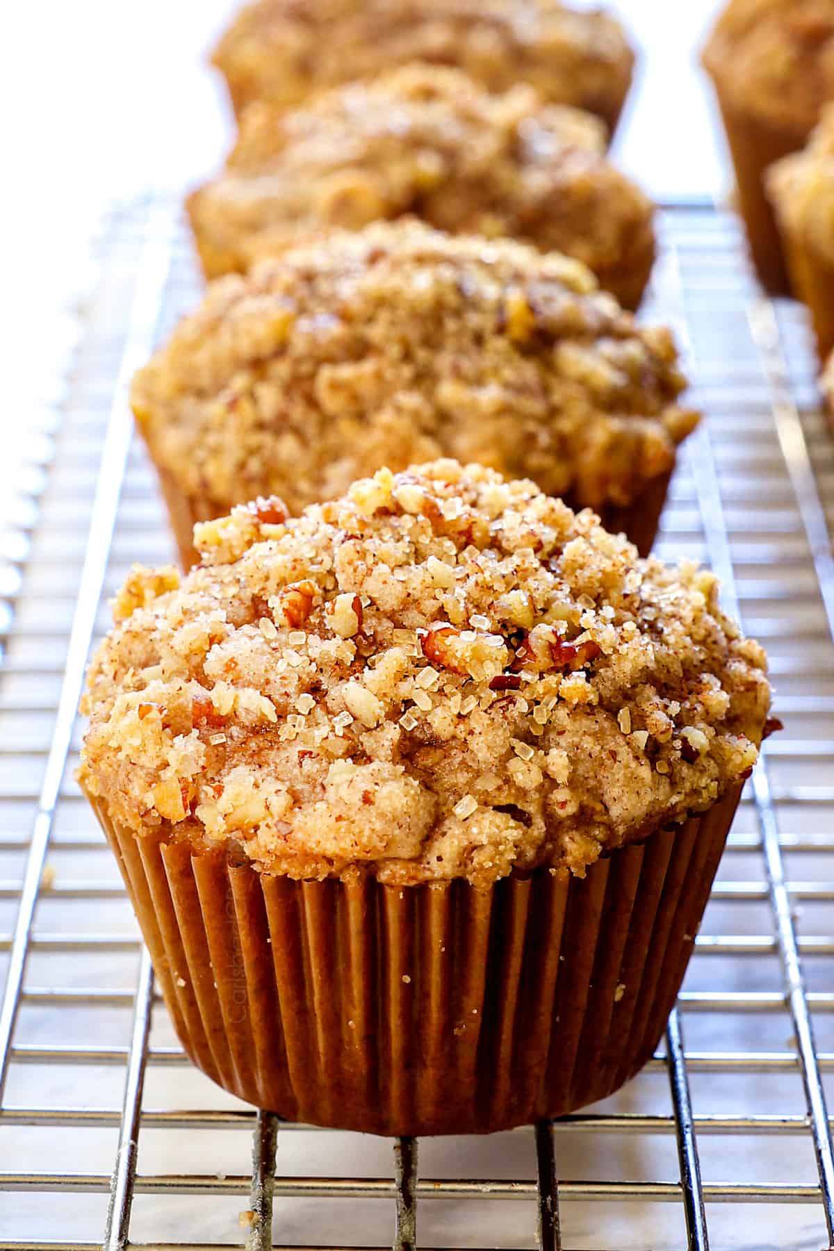 showing how to make pumpkin cream cheese muffins by cooling the muffins on a wire rack