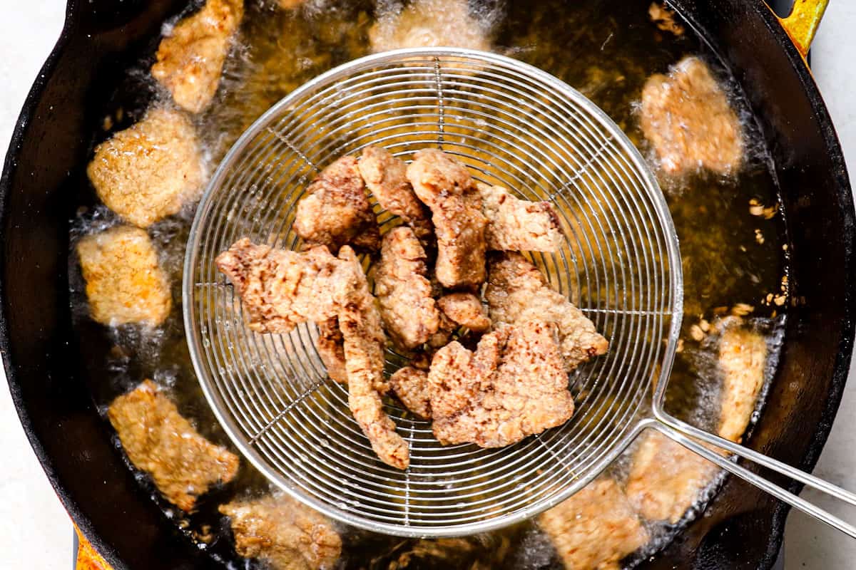 showing how to make Beijing Beef by frying the  beef in oil