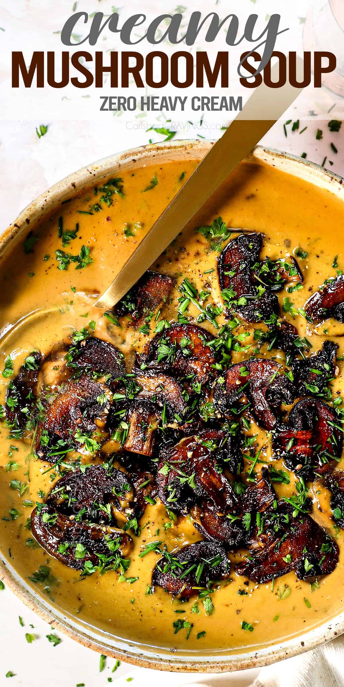 top view of cream of mushroom soup in a bowl garnished with thyme and parsley