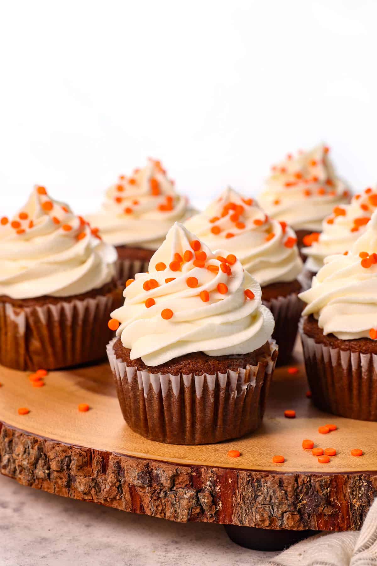 pumpkin spice cupcakes lined up on a platter