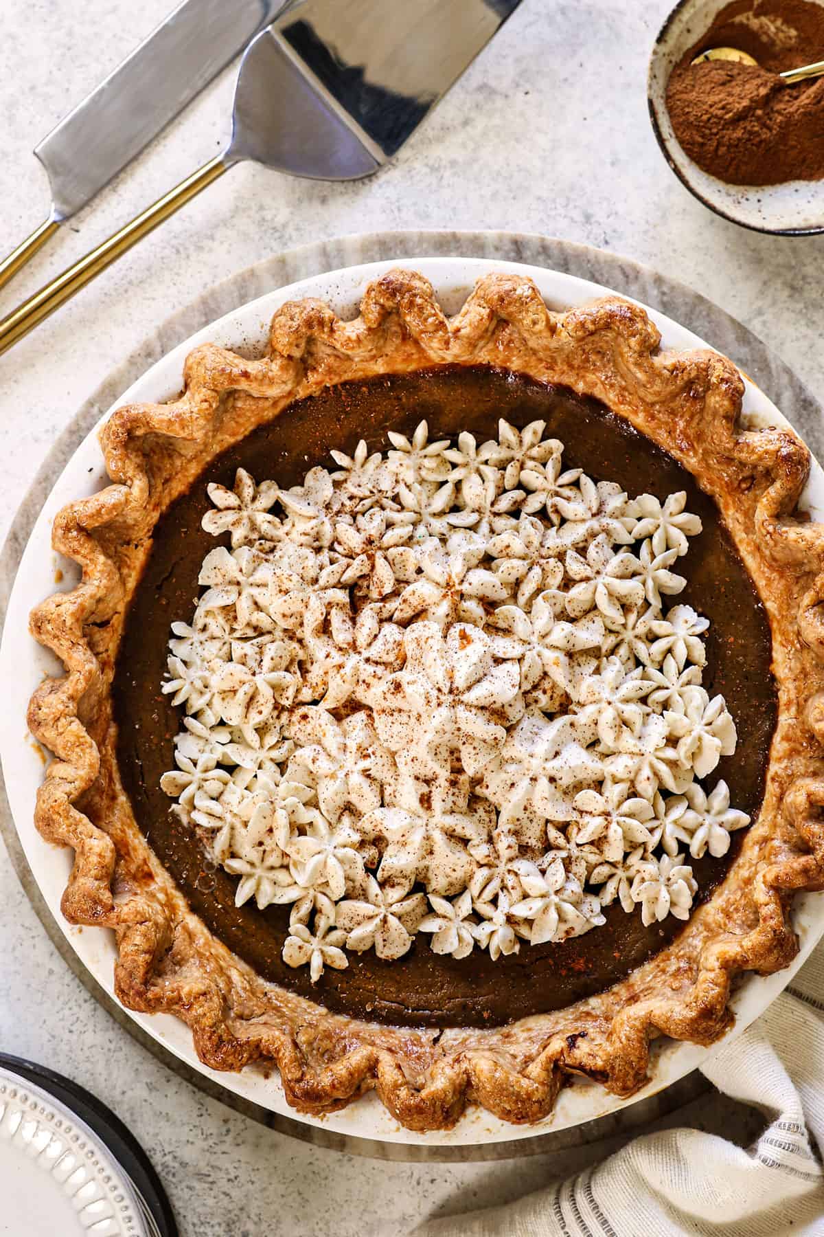 top view of pumpkin pie in homemade crust topped with whipped cream