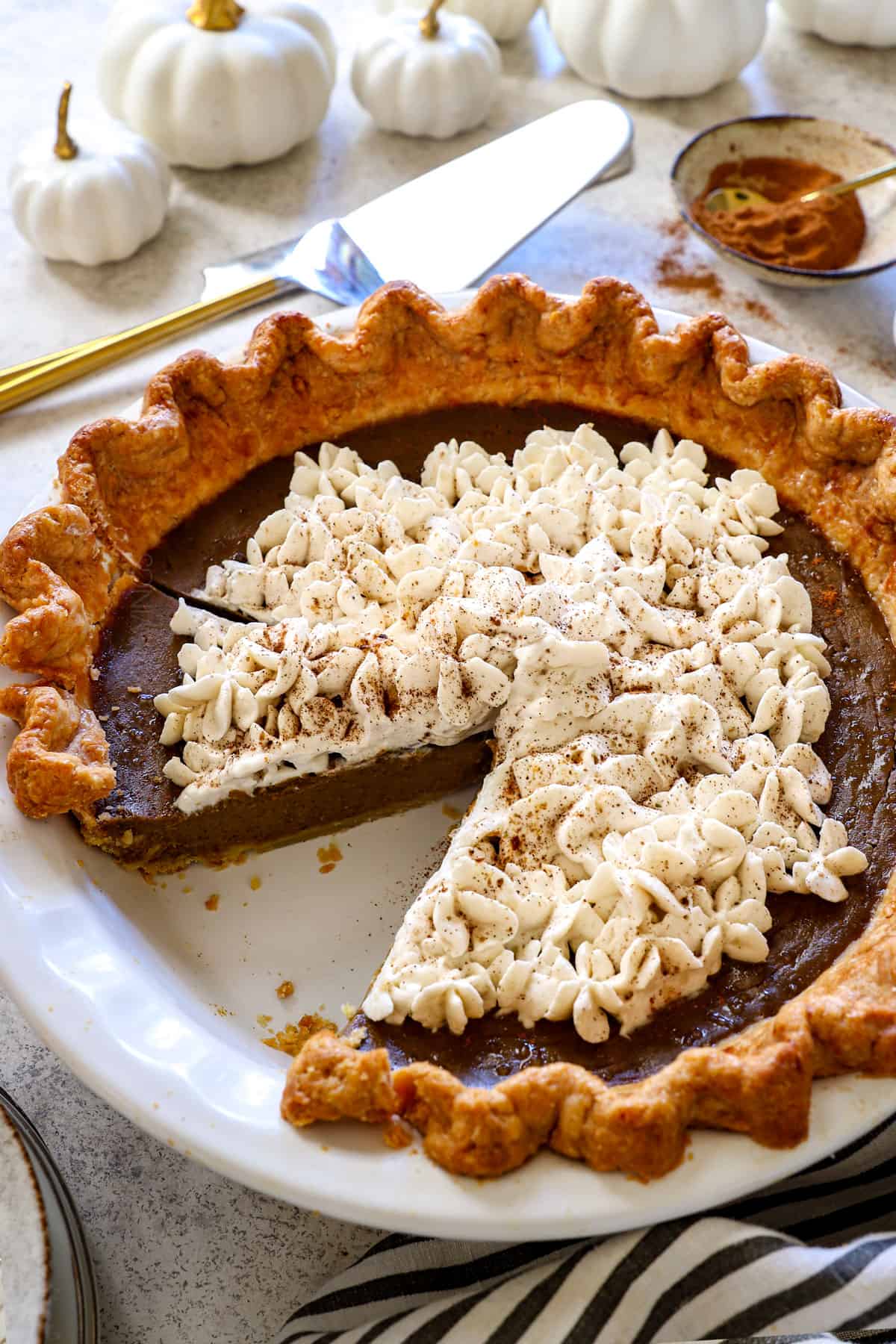 pumpkin pie from scratch garnished with whipped cream and cinnamon