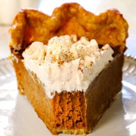 a slice of best pumpkin pie with a bite taken out showing how creamy it is