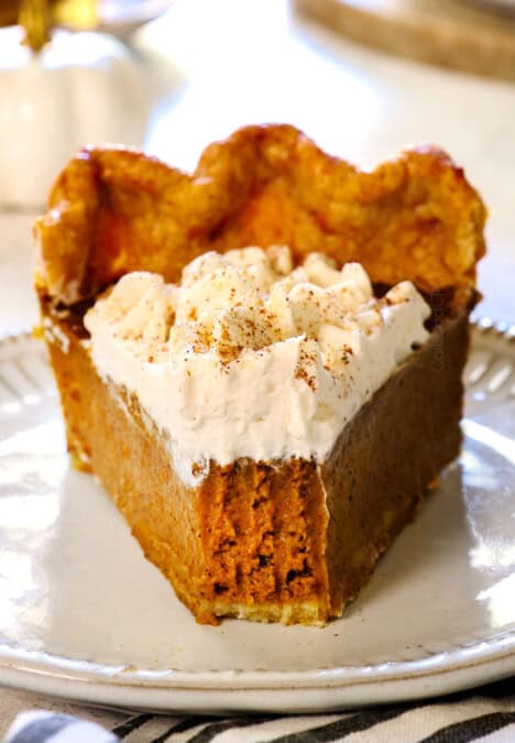 a slice of best pumpkin pie with a bite taken out showing how creamy it is