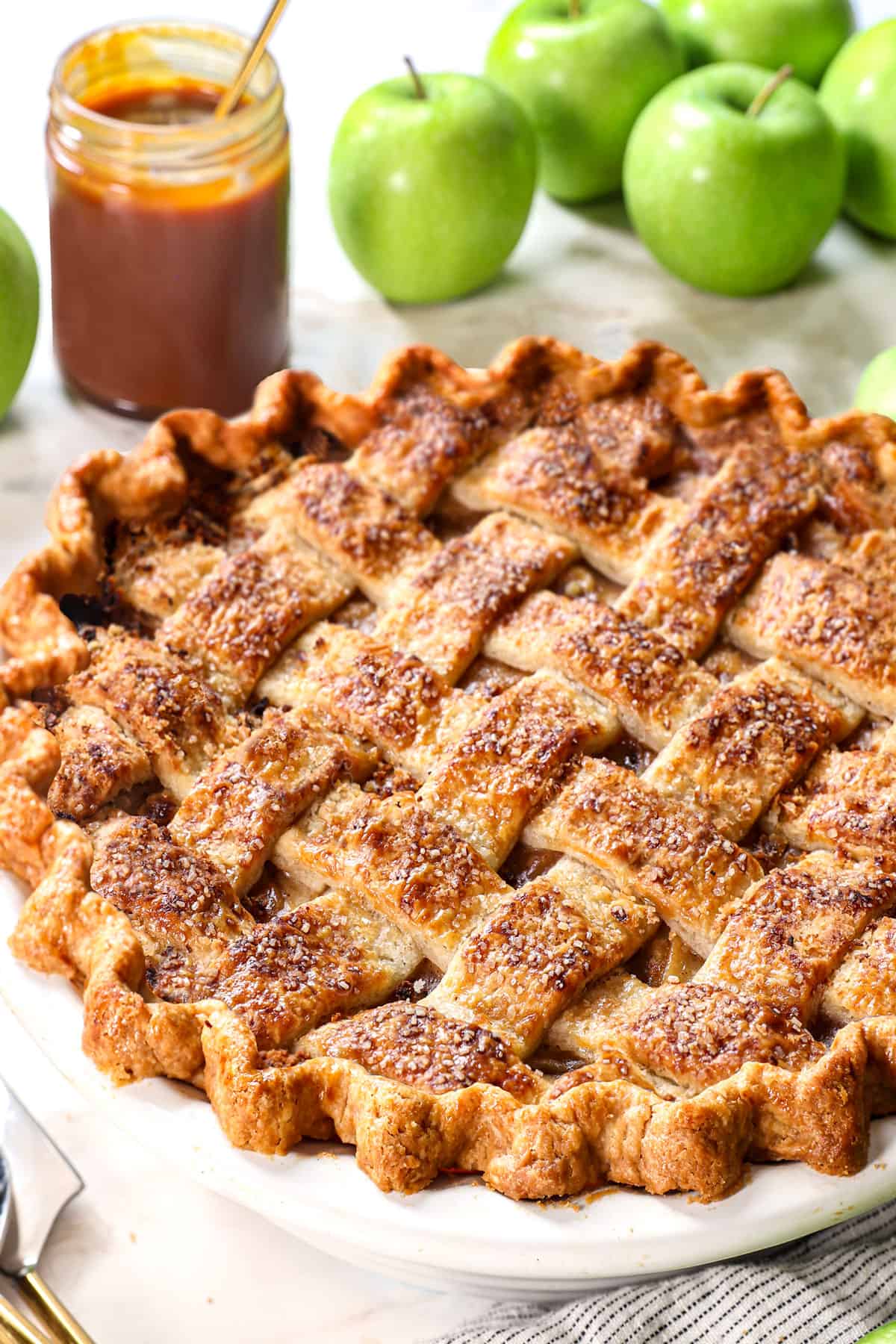 the best apple pie recipe with a golden lattice top sprinkled with coarse sugar