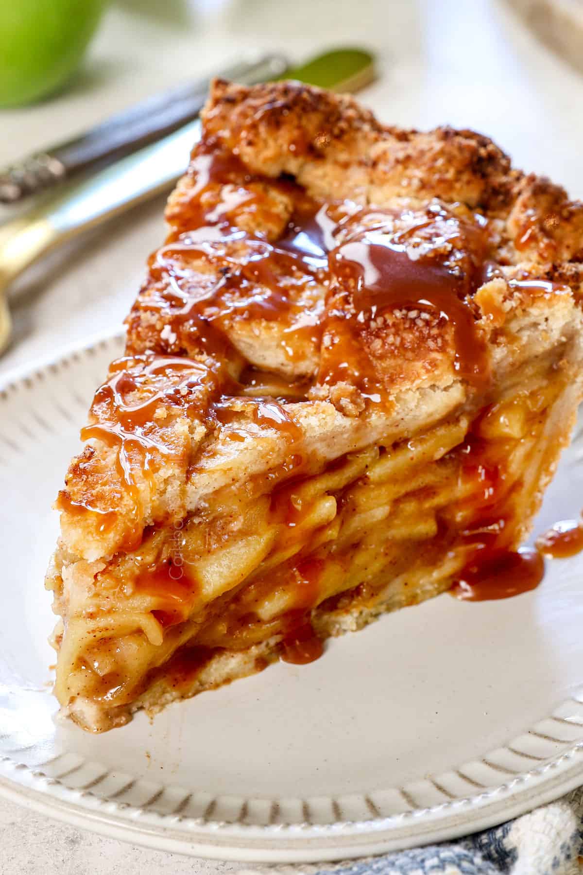 traditional apple pie recipe with a lattice top being served on a plate