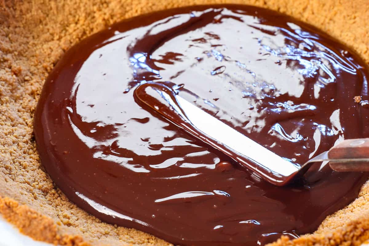 showing how to make Banana Cream Pie by spreading the ganache onto the bottom of the pie crust