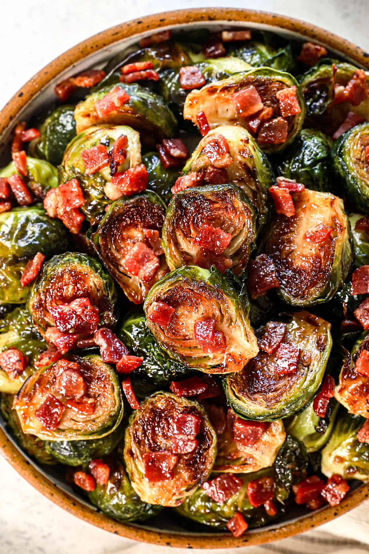 Brussels sprouts with bacon served in a bowl showing how crispy they are