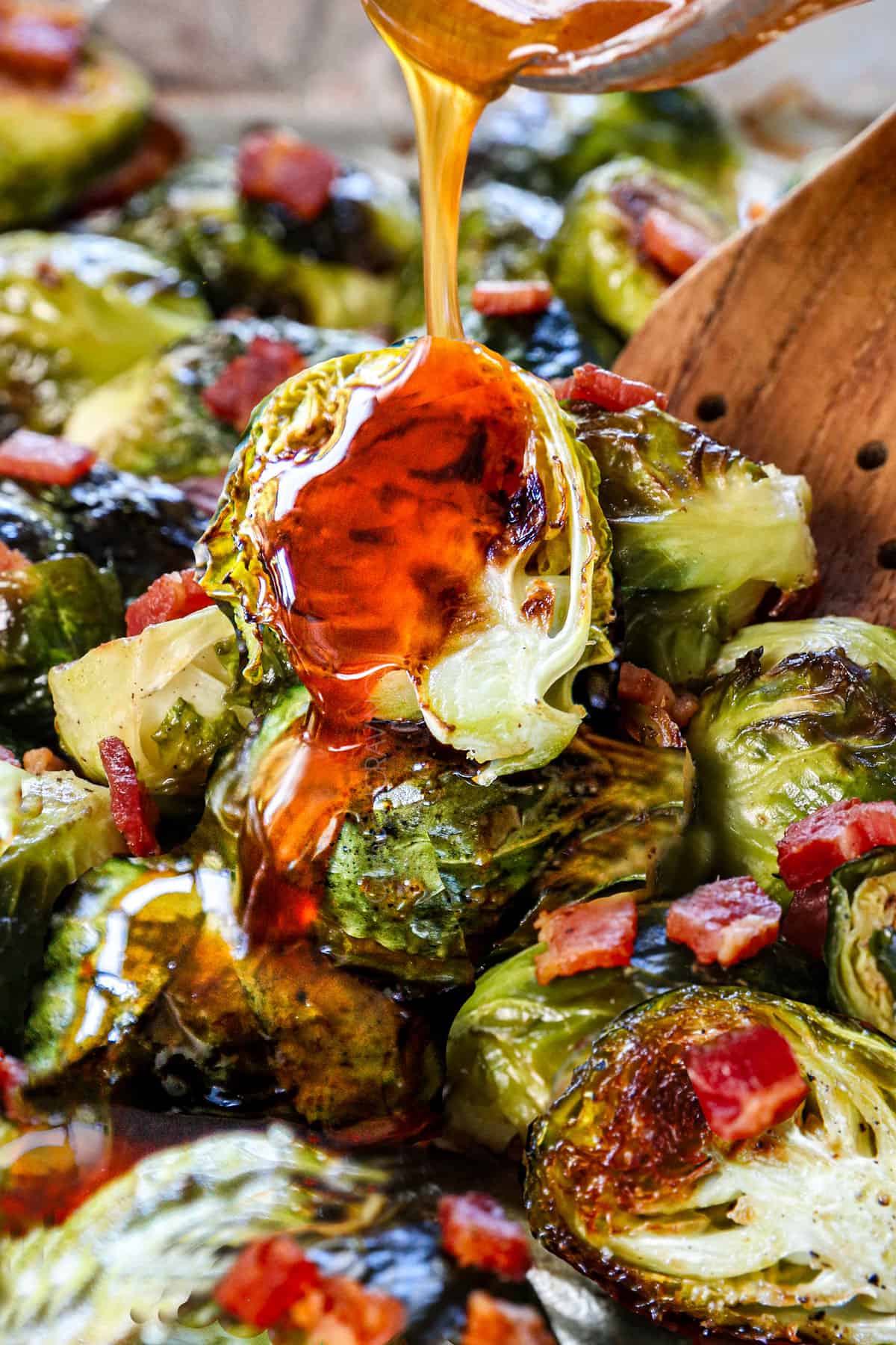 showing how to make Brussel sprouts with bacon by drizzling with honey sriracha glaze