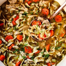 top view of a pot of turkey noodle soup showing how chunky the soup is