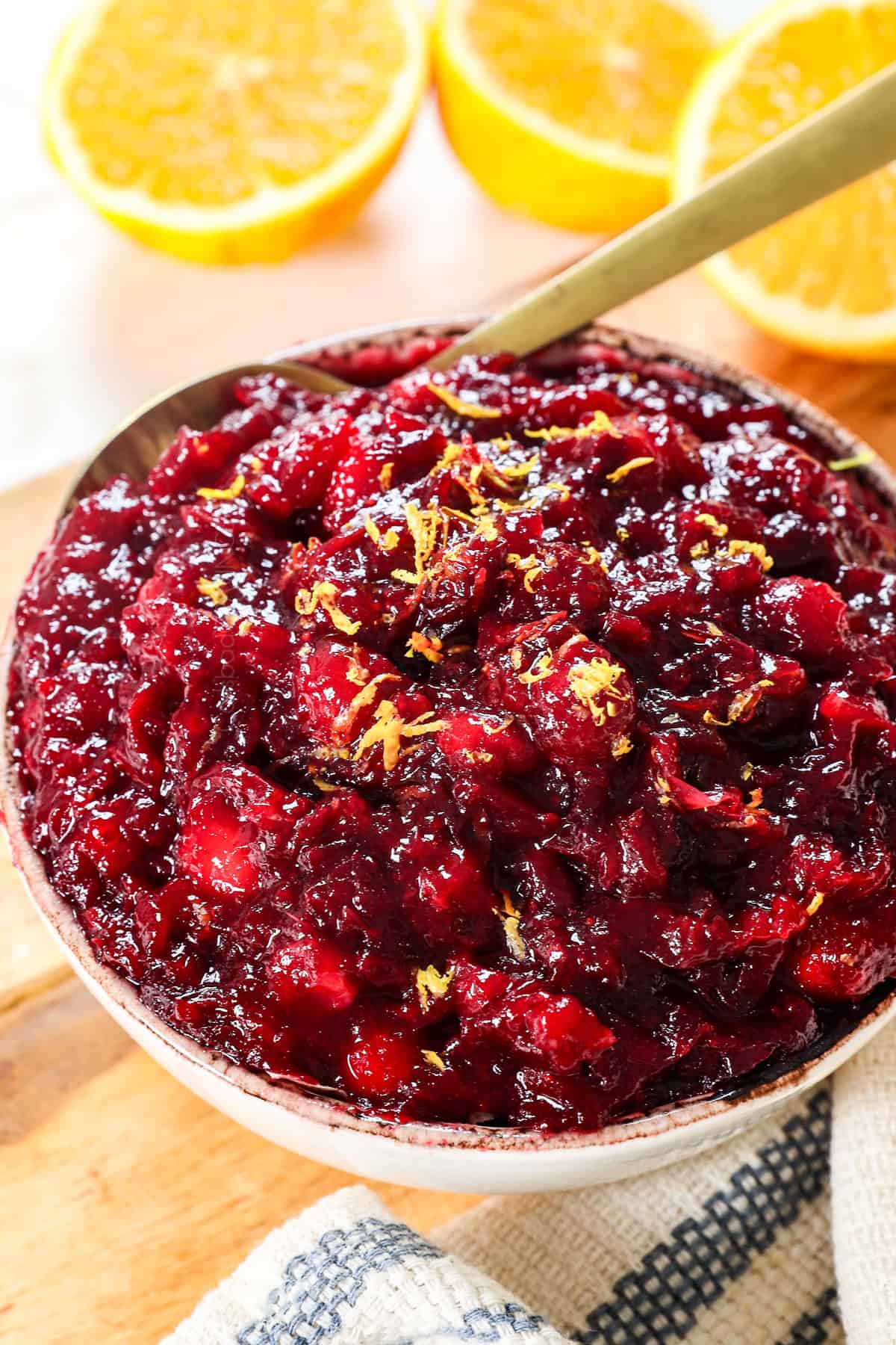 showing how to make cranberry sauce by transferring to a bowl to cool