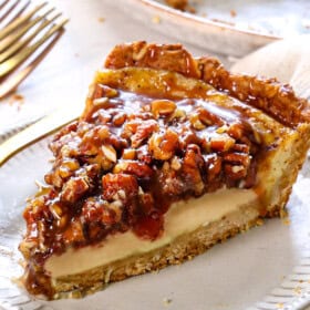 a slice of old fashioned custard pie made with eggs, sugar, vanilla, nutmeg, milk and cream on a plate