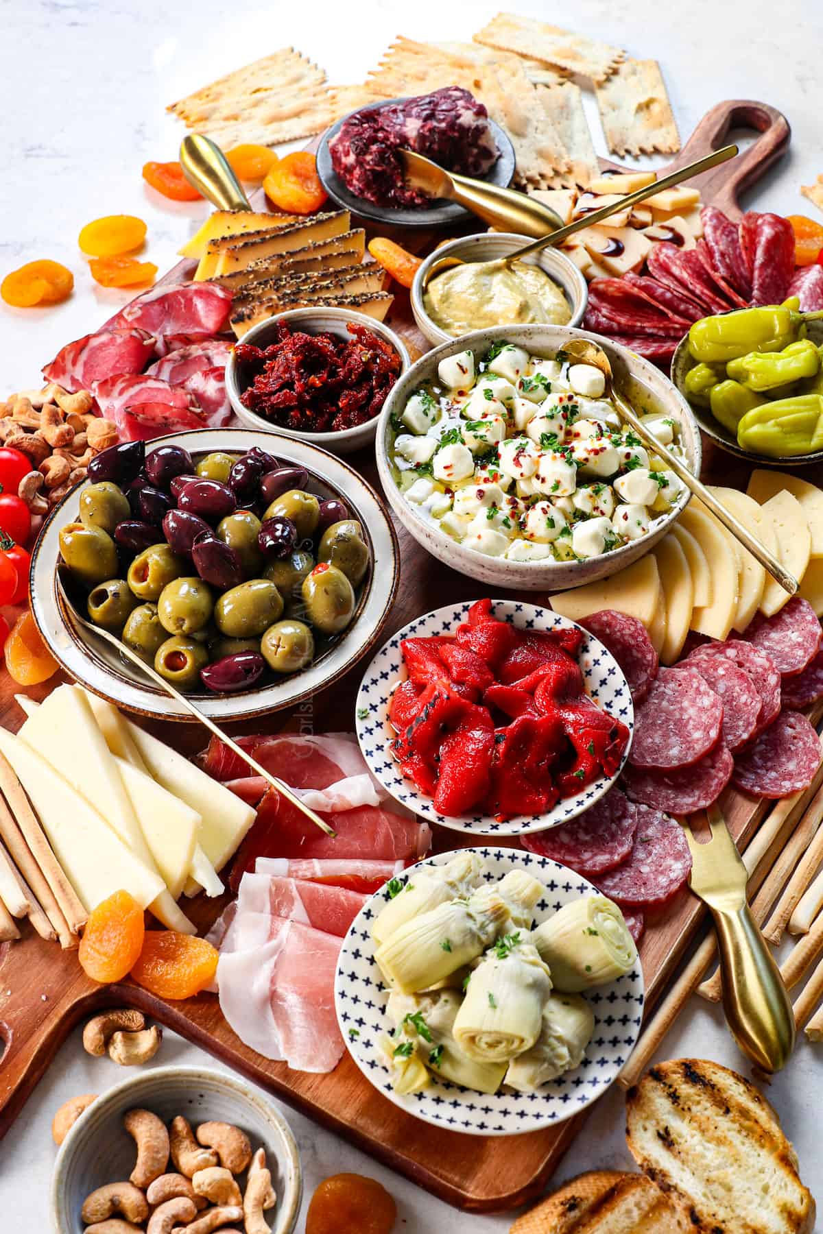 side view of antipasto platter showing the meats, cheeses, and brined vegetables