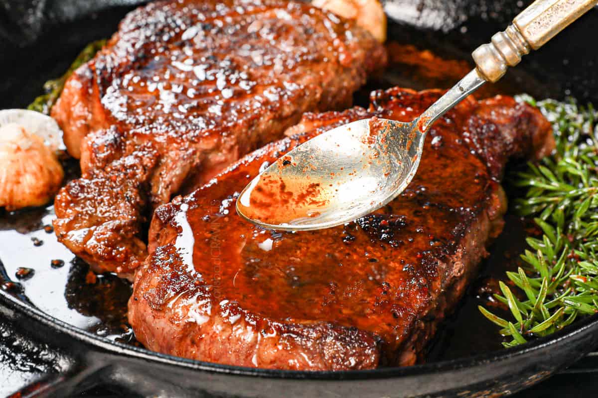 showing how to cook ribeye steak by basting with butter