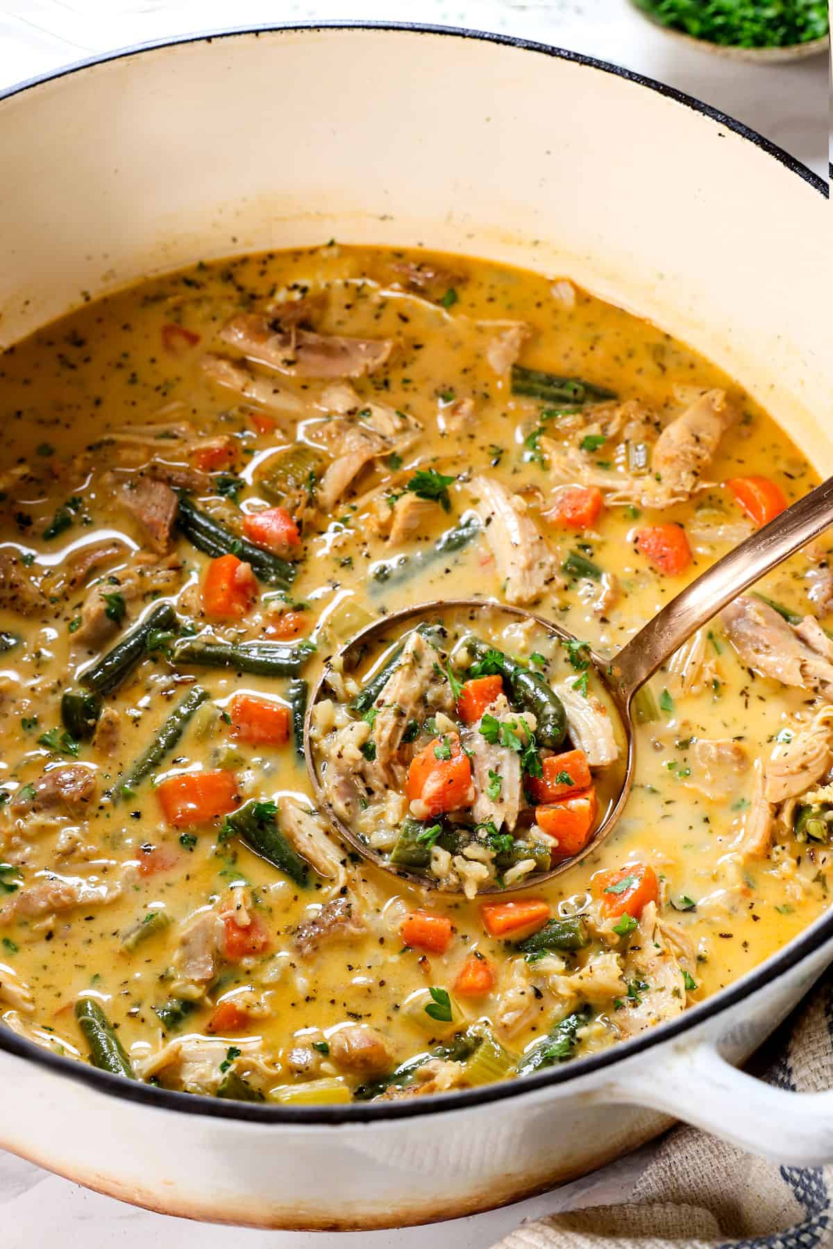 a ladle of chicken and rice soup recipe showing the creamy texture of the broth