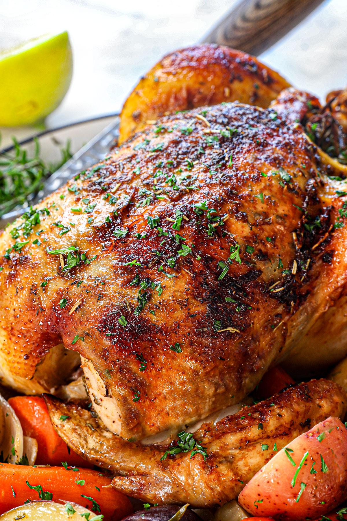 up close of roasted whole chicken to see how crispy the skin is and juicy the chicken is