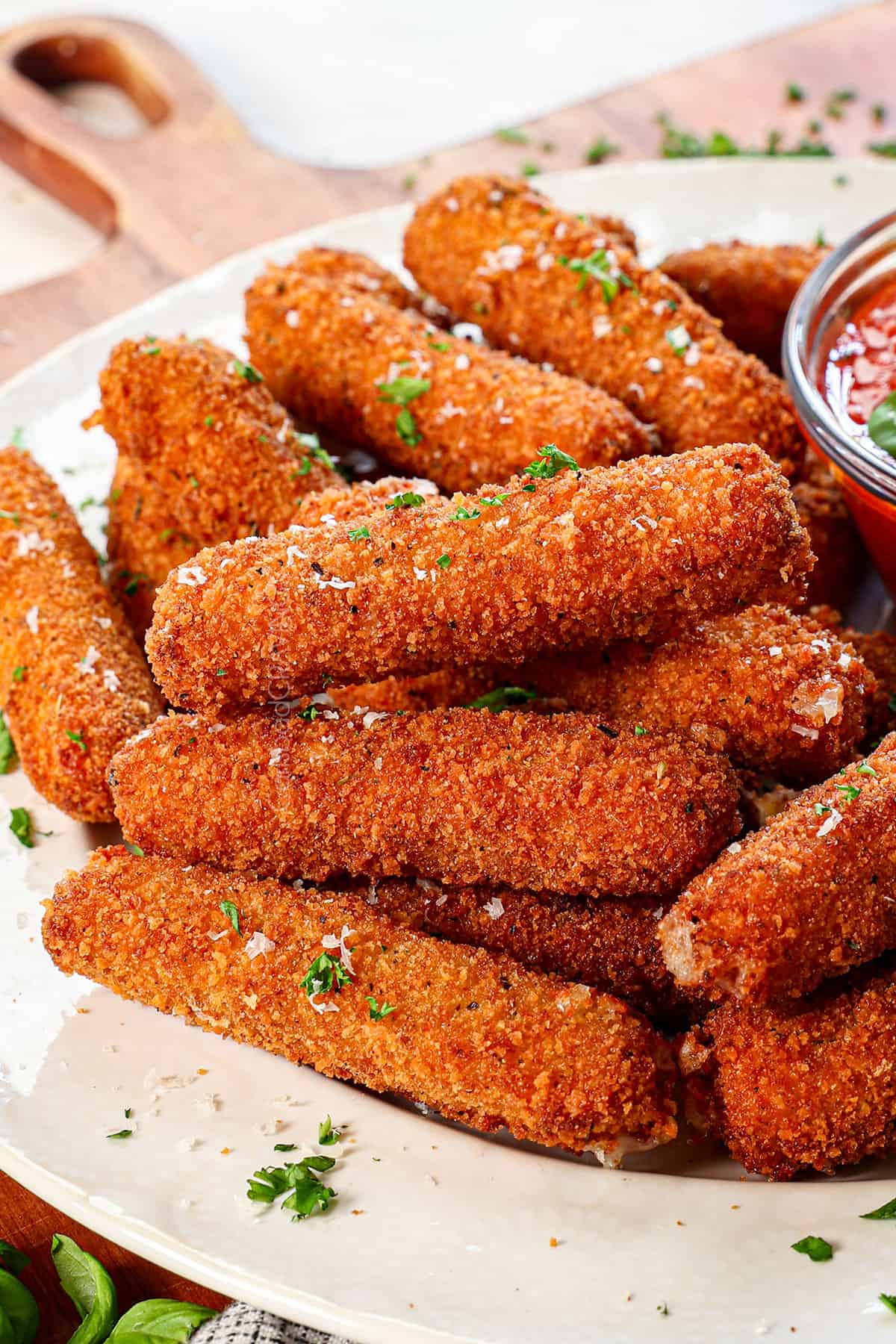 a stack of homemade mozzarella sticks showing how crispy they are