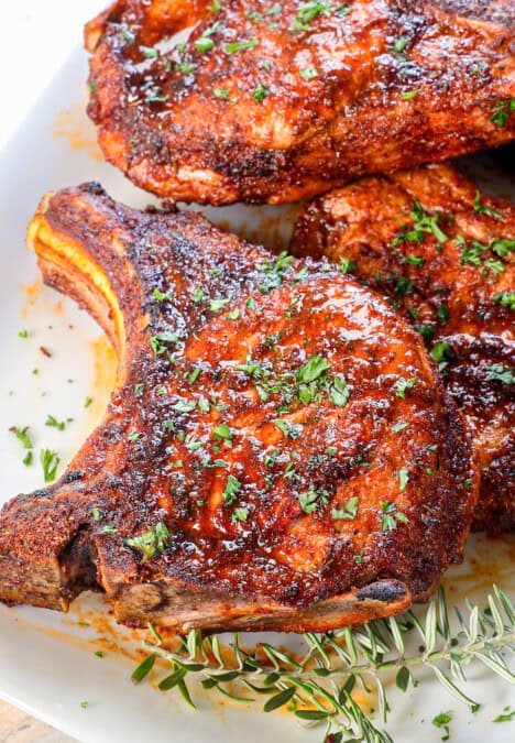 up close of pork chop air fryer spice rubbed and garnished with fresh parsley