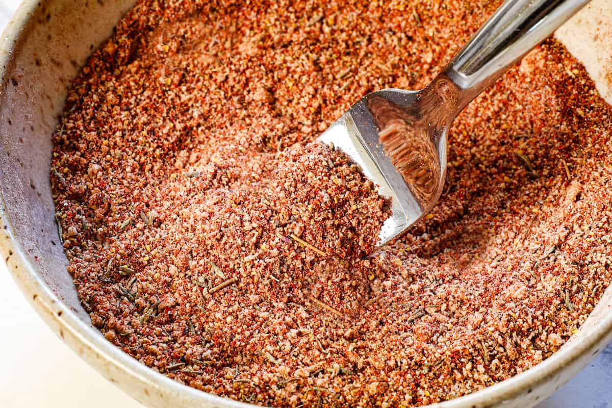 showing how to air fry pork chops by whisking the spices together in a bowl to make a spice rub