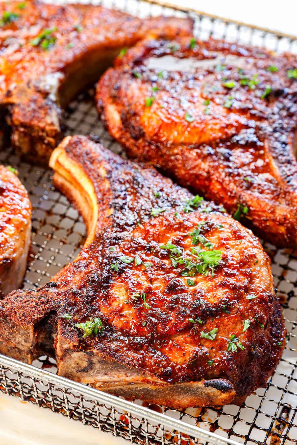 showing how to air fry pork chops by air frying until golden