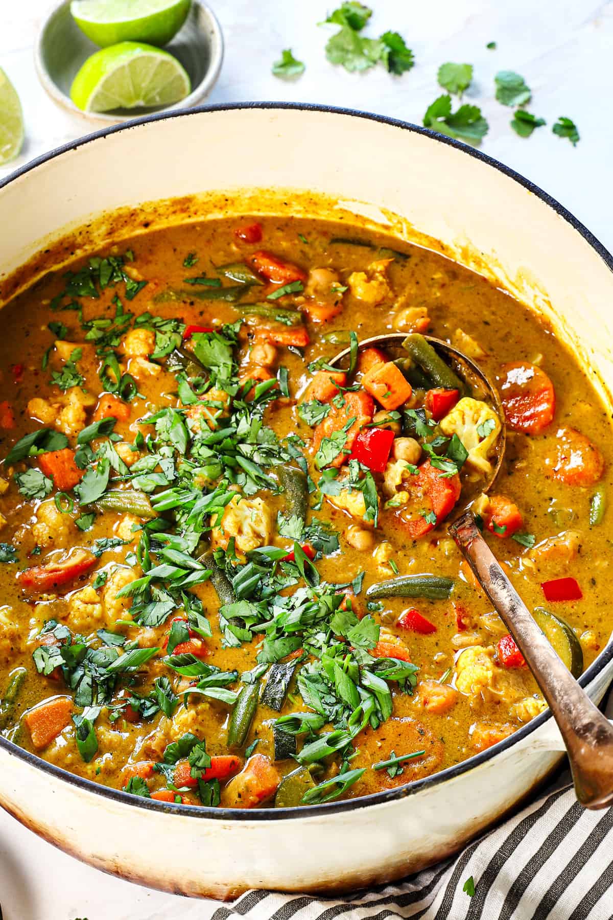 showing how to make vegetable soup by adding cilantro and lime juice