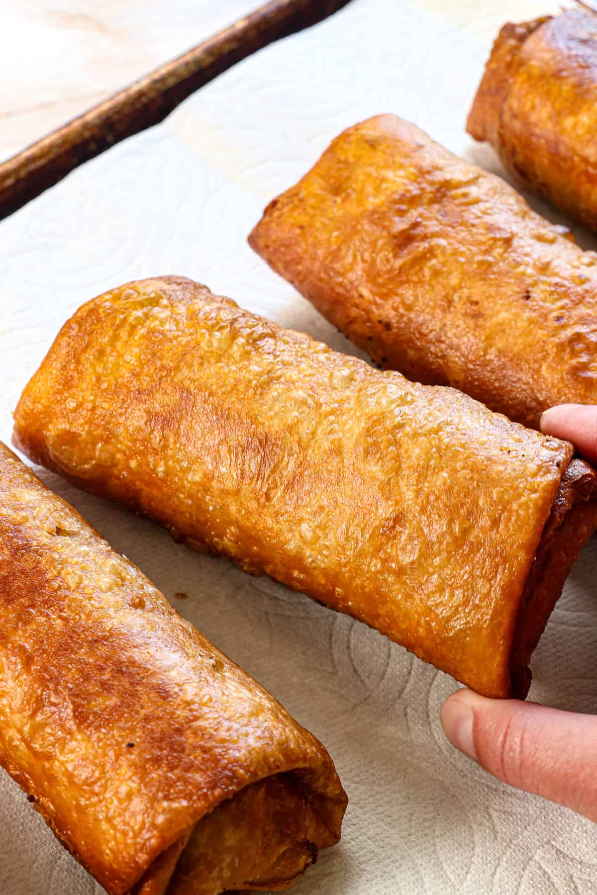showing how to make chimichangas by draining on paper towels