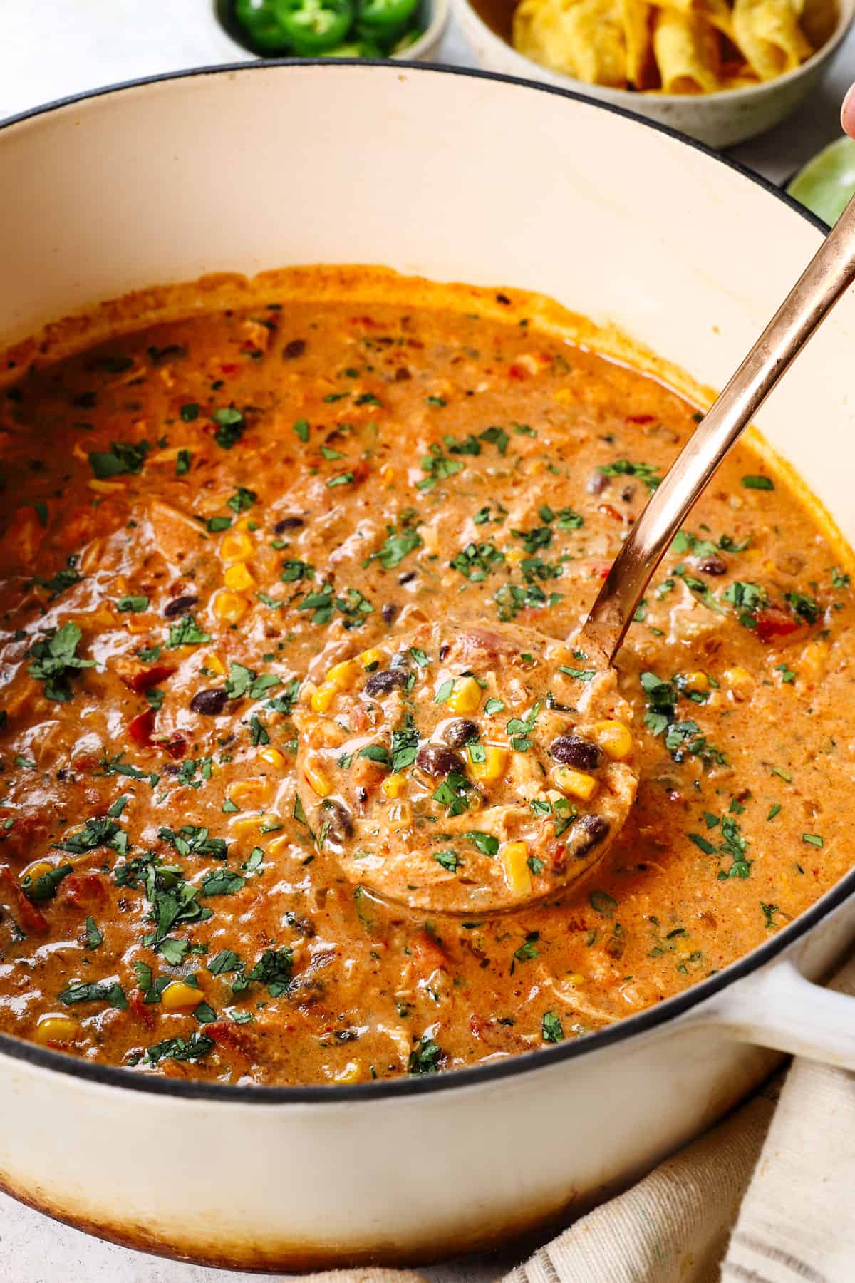 Taco chicken soup in  Dutch oven garnished with cilantro