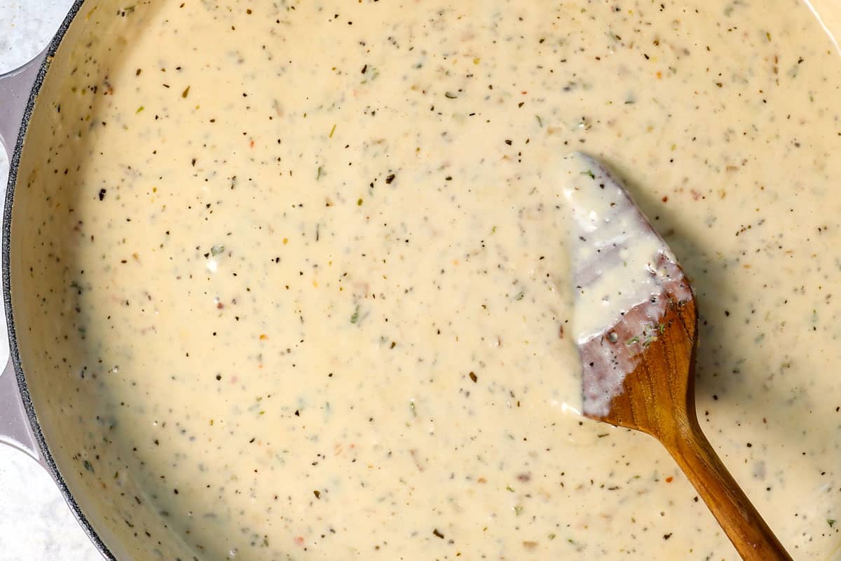 showing how to make Chicken Parmesan pasta by simmering until the sauce is thickened