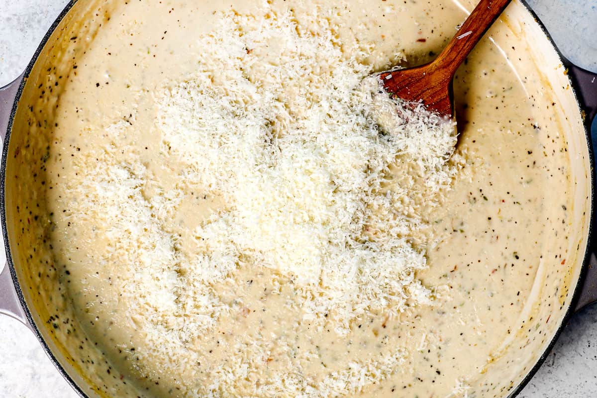 showing how to make Chicken Parmesan pasta by stirring in the Parmesan to melt