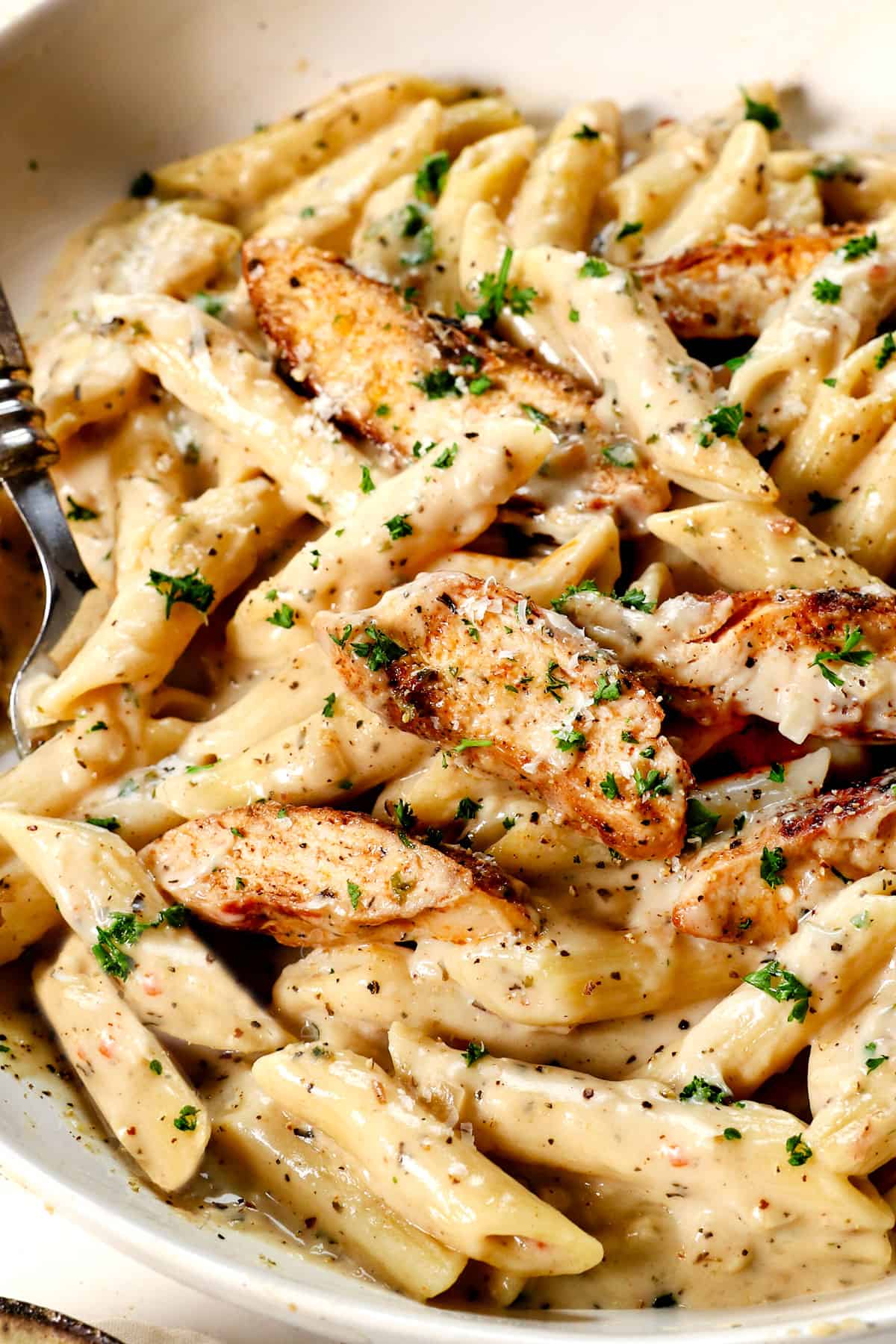 up close of a bowl of garlic parmesan chicken showing how juicy it is