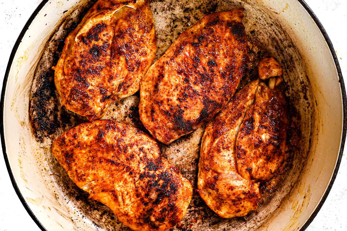 showing how to make Chicken Parmesan pasta by cooking the chicken until seared and cooked through